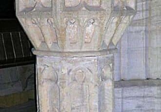 A large stone font, with blocky engraved panels.