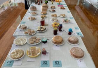 A table full of cakes, jams, scones and biscuits ready to be judged.