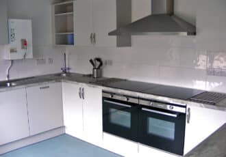 A large, clean kitchen with a microwave, electric cooker, large fridge & instant hot water tap.